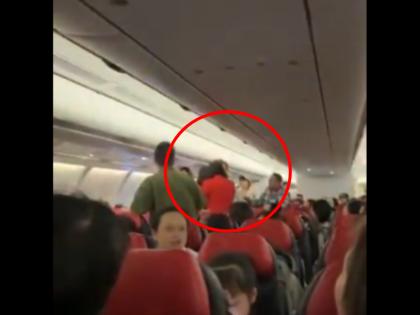 AirAsia Flight Video Woman was talking loudly in flight slapped man when he objected High voltage drama in plane | VIDEO: फ्लाइट में तेज आवाज में बात कर रही थी महिला, मना करने पर शख्स को जड़ा थप्पड़; एयरएशिया विमान में हाई वोल्टेज ड्रामा