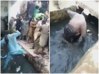 Video pakistan Man pushes others into drain in crowd for flour clip goes viral | पाकिस्तान: आटे के लिए लगी भीड़ में शख्स ने दूसरे लोगों को नाले में ढकेला, वीडियो हुआ वायरल