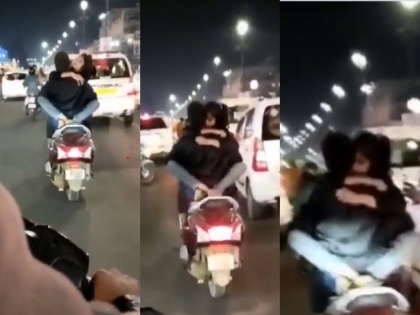 Girl hugs boy on moving scooty in Lucknow video goes viral police takes accused custody | बीच सड़क पर नाबालिक लड़की ने युवक को चलती स्कूटी पर लगाया गले, वीडियो वायरल