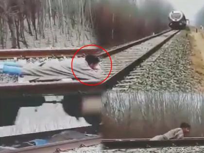 kashmiri boy stunt on railway track train passes over him body viral video | वायरल वीडियो: कश्मीरी लड़के का ये स्टंट देख रूक जाएंगी आपकी सांसे, उमर अब्दुल्ला ने किया शेयर