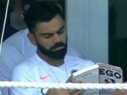 India vs West Indies: Virat Kohli trolled for reading 'Detox Your Ego' book in dressing room during 1st Test | IND vs WI: विराट कोहली मैच के दौरान ड्रेसिंग रूम में ये 'खास' किताब पढ़ते आए नजर, फैंस ने जमकर किया ट्रोल